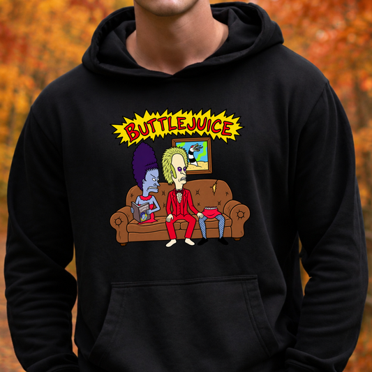 A person wearing a black pullover hoodie with a colorful graphic print on the chest. The graphic features the text 'BUTTLEJUICE' in yellow above two cartoon characters sitting on a brown couch.