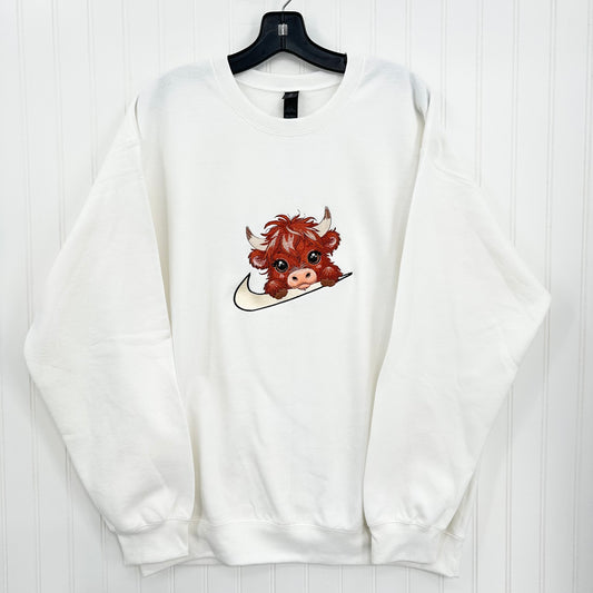 highland cow on nike swoosh on white sweatshirt