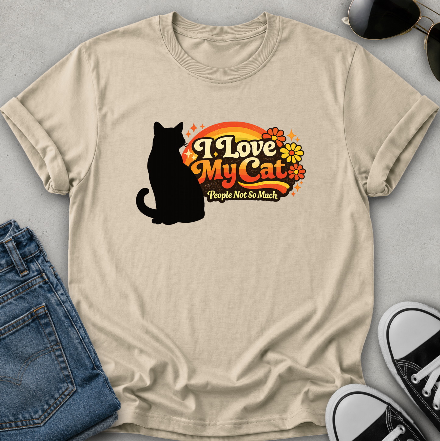 A beige short-sleeve t-shirt with a graphic on the front showing a black cat silhouette next to the text 'I Love My Cat' in orange and yellow, with the tag 'Gildan' visible inside the collar, set against a light gray background.