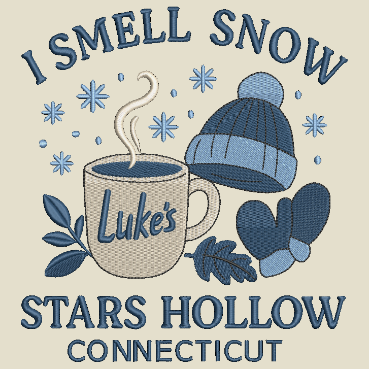 Embroidered-style graphic design on a light beige background featuring the text 'I SMELL SNOW' at the top and 'STARS HOLLOW CONNECTICUT' at the bottom, with a mug reading 'Luke's', a blue knit hat, blue mittens, and snowflake motifs.