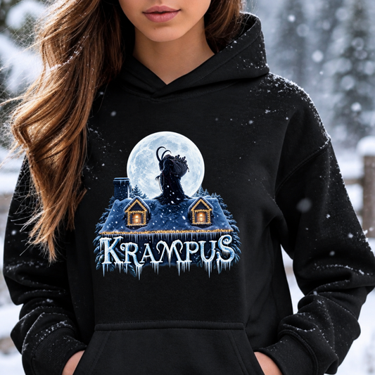 A woman wearing a black hoodie with a graphic print of a Krampus figure in front of a full moon over snow-covered houses, with the word 'KRAMPUS' below. The background is a snowy outdoor scene.