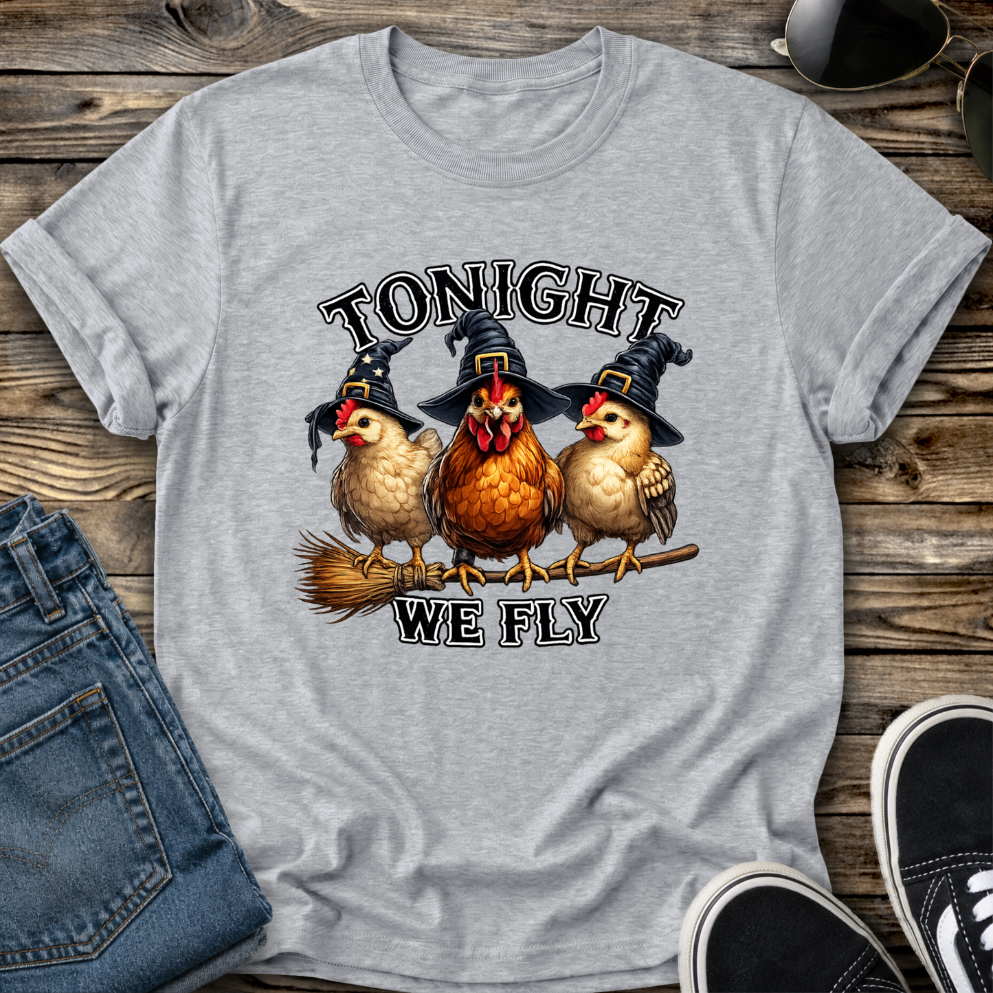 gray tshirt with funny chicken witches on a broomstick graphic design that says tonight we fly