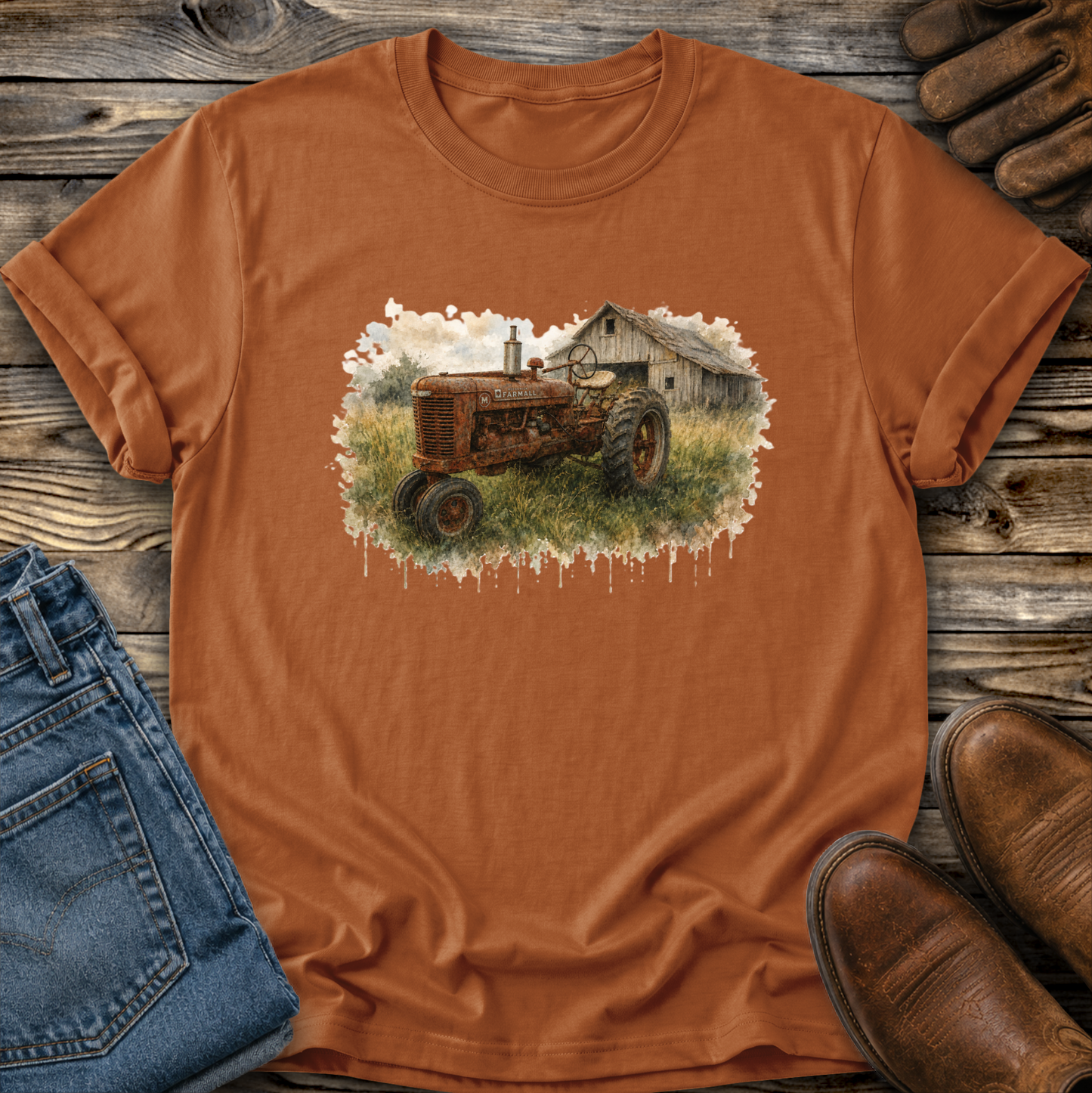 orange tshirt with a watercolor barn and rusty farmall tractor farm scene graphic on it