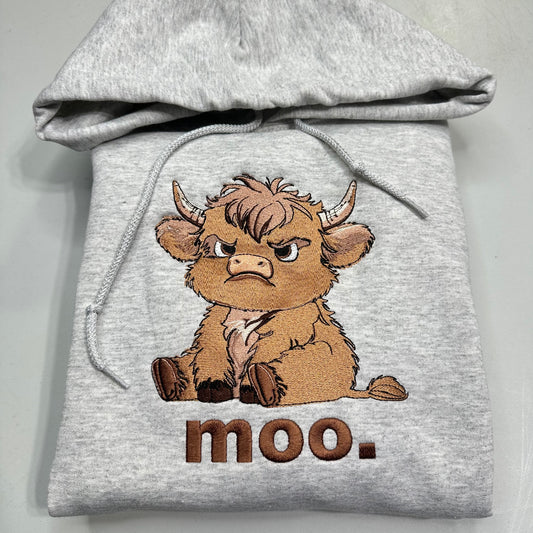 Gray hoodie with a cartoon highland cow and 'moo.' text on a light gray background