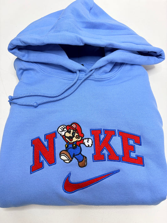 Blue hoodie with mario bros character design and 'NKE' text on a white background