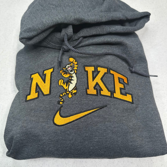gray sweatshirt with embroidered tigger in the middle of the nike logo