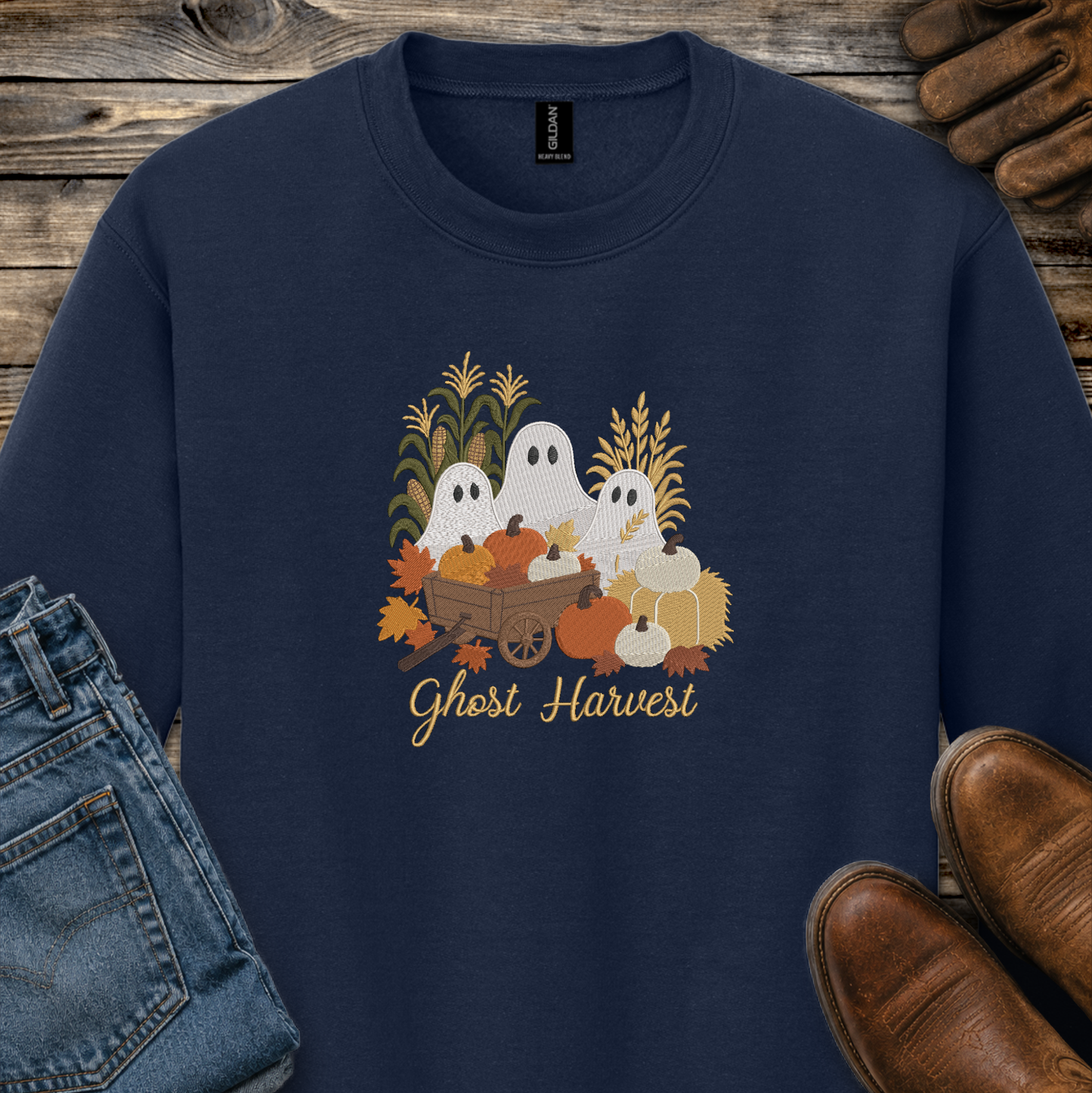 navy blue sweatshirt with a fall season embroidered design of ghosts, pumpkins and leaves.
