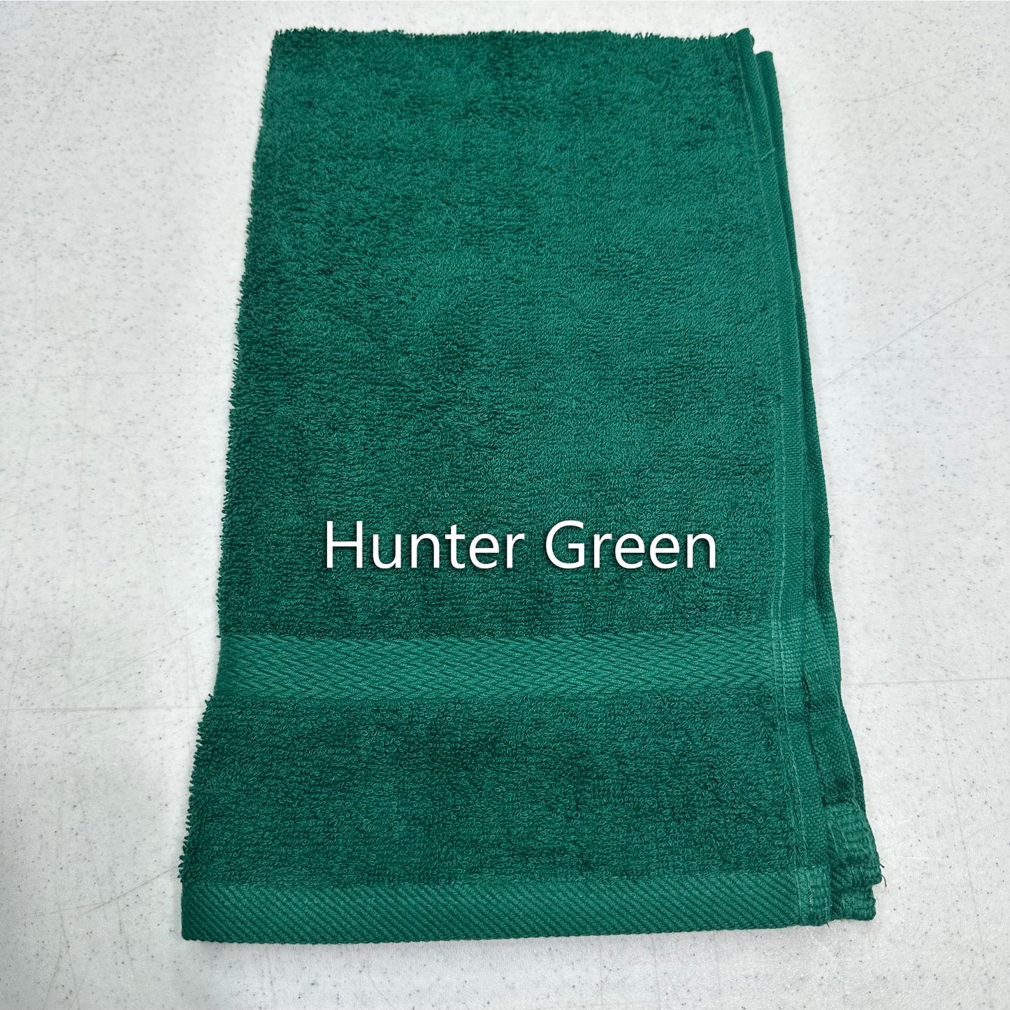 Folded hunter green towel on a light gray background with 'Hunter Green' text.