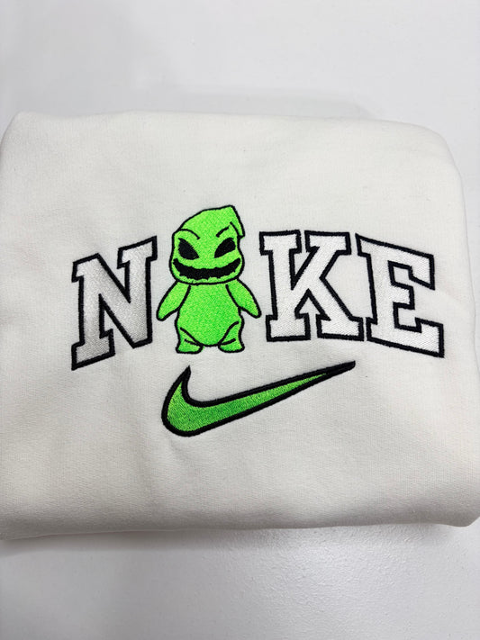 white sweatshirt with an embroidered oogie boogie in the nike logo