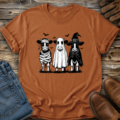 orange tshirt with funny graphic of 3 cow dressed up in halloween costumes