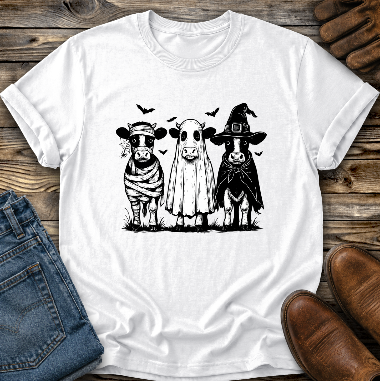 white tshirt with funny graphic of 3 cow dressed up in halloween costumes