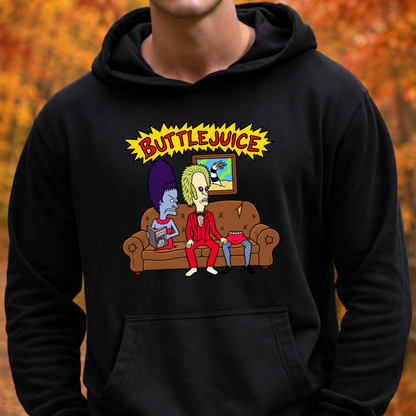 A person wearing a black pullover hoodie with a colorful graphic print on the chest. The graphic features the text 'BUTTLEJUICE' in yellow above two cartoon characters sitting on a brown couch.