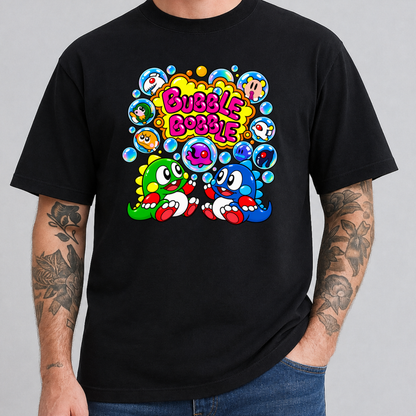 A man wearing a black t-shirt with a colorful retro cartoon graphic on the chest featuring the text 'Bubble Bobble' and two cartoon characters, shown against a plain gray background.