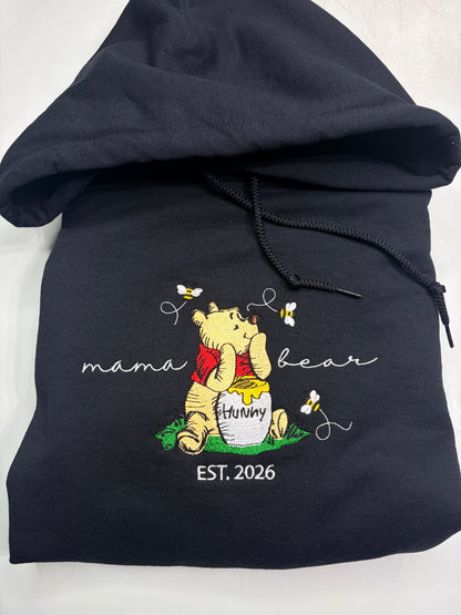black hoodie with winnie the pooh embroidered on it and says mama bear
