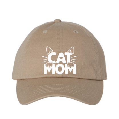 A beige baseball cap with a white graphic on the front that reads 'CAT MOM' with cat ears and paws, shown against a plain white background.