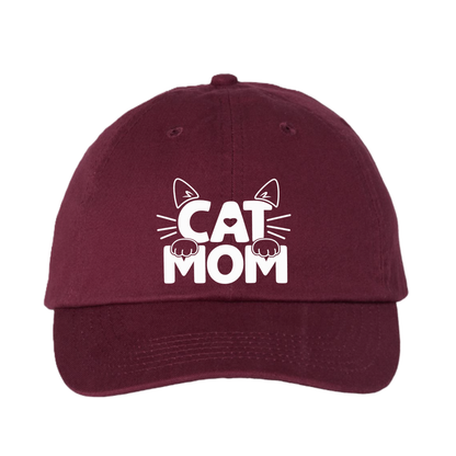 A maroon baseball cap with a white graphic on the front that reads 'CAT MOM' with cat ears and paws, shown against a plain white background.