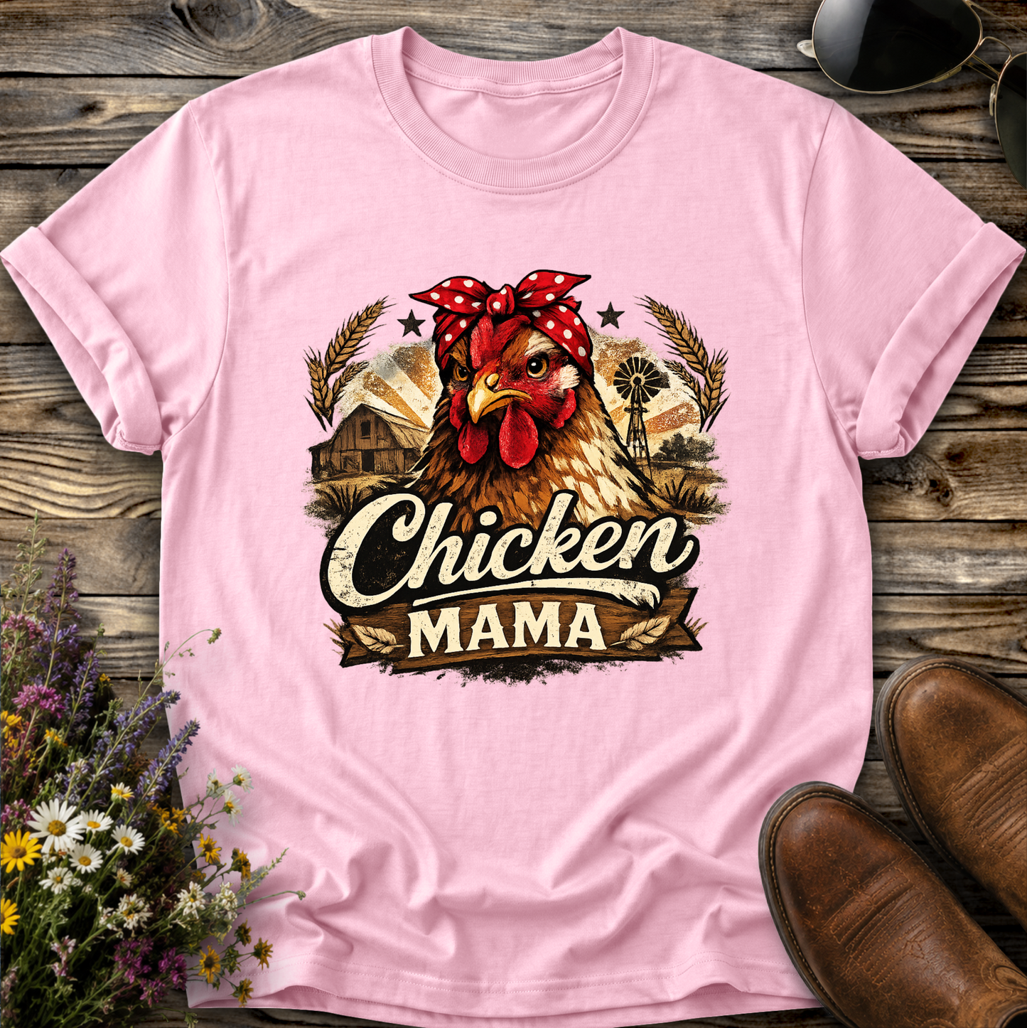 light pink tshirt with a country farm scene and  a chicken with a bandana on and it says chicken mama