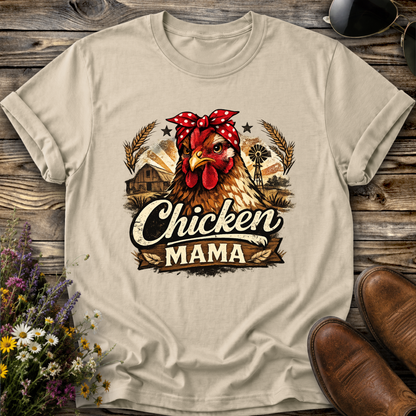 beige tshirt with a country farm scene and  a chicken with a bandana on and it says chicken mama