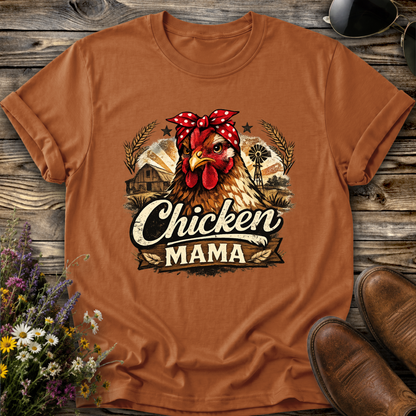 orange tshirt with a country farm scene and  a chicken with a bandana on and it says chicken mama