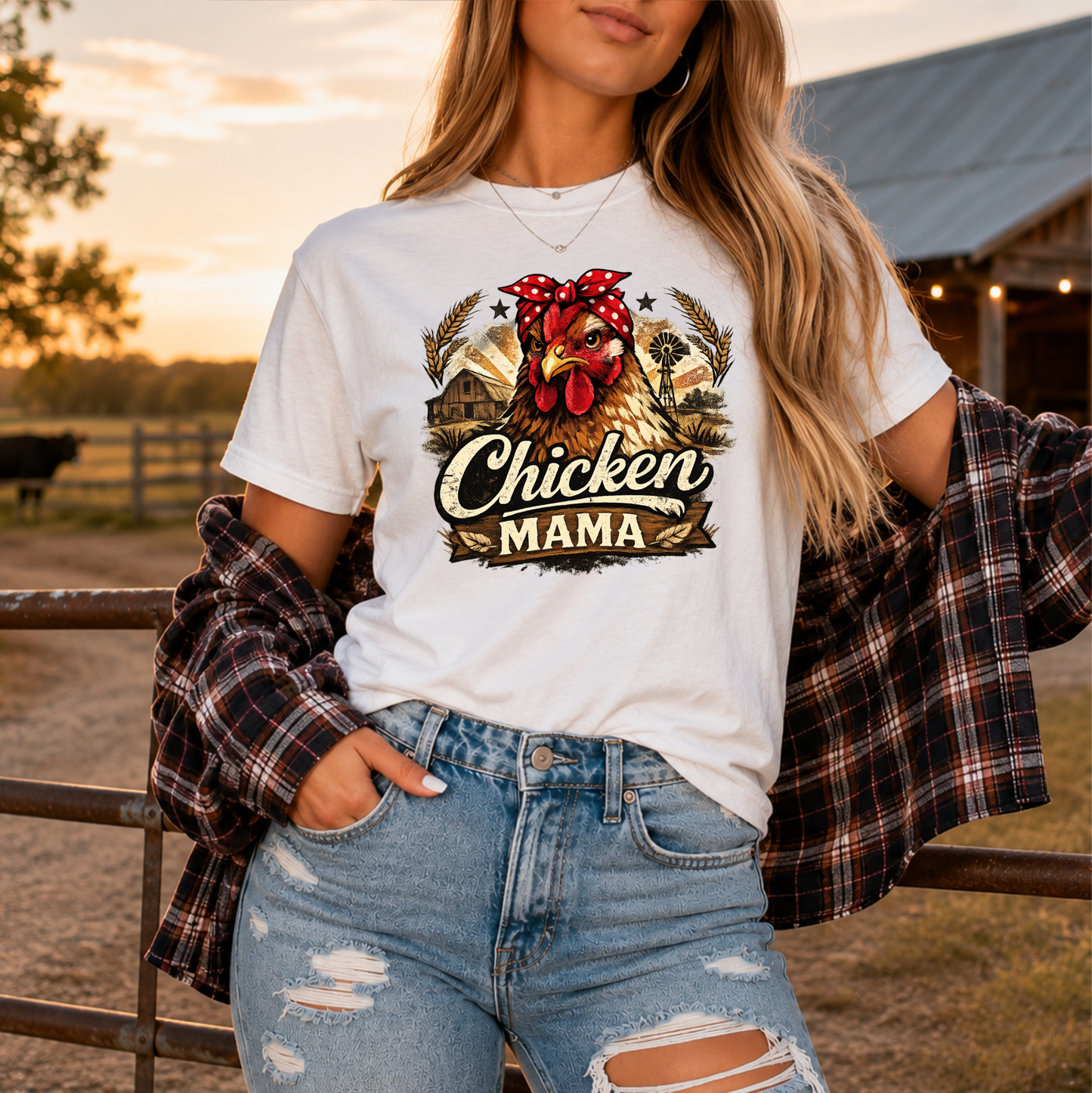 woman wearing a white tshirt with a country farm scene and  a chicken with a bandana on and it says chicken mama