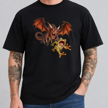 A man wearing a black short-sleeve t-shirt with a graphic print of a red dragon and a green frog, paired with blue jeans against a solid gray background.