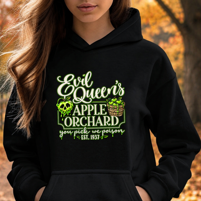 woman wearing a black hoodie with a graphic design that says evil queen's apple orchard you pick we poison on it