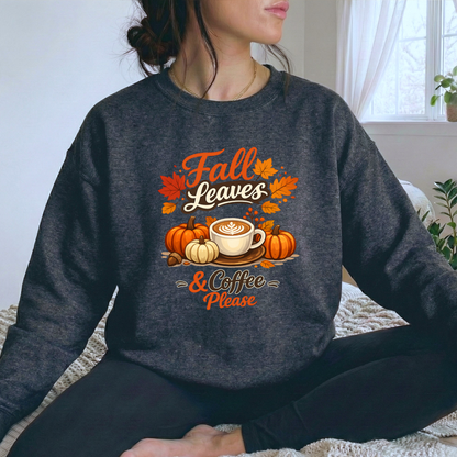 woman wearing a gray sweatshirt with fall autumn pumpkin scene graphic design that says fall leaves and coffee please