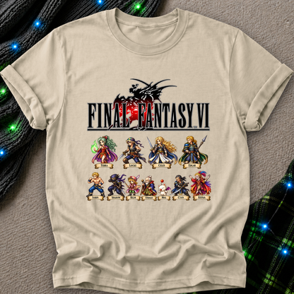 A beige graphic t-shirt featuring the Final Fantasy VI logo and character lineup print, laid flat on a gray textured surface with festive green and blue string lights in the background.