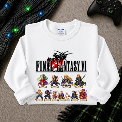 A white Gildan sweatshirt featuring a Final Fantasy VI graphic print, laid flat on a gray textured surface with a black controller, green lights, and a plaid blanket in the background.