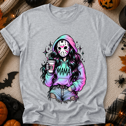 A heather gray short-sleeve t-shirt with a colorful graphic of a woman in a hockey mask and pastel rainbow hoodie holding a coffee cup, styled in a flat-lay with Halloween props.