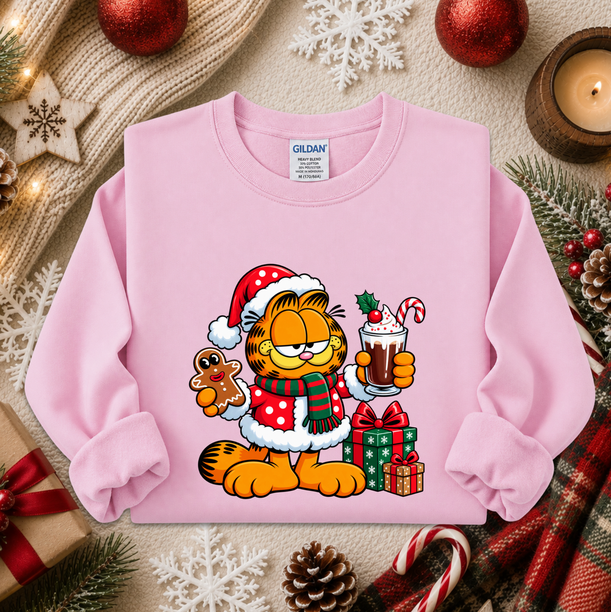 light pink sweatshirt with a christmas themed graphic of garfield in a santa costume with presents and food