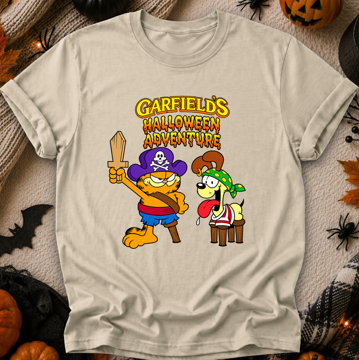 beige tshirt with graphic of garfields halloween adventure on it