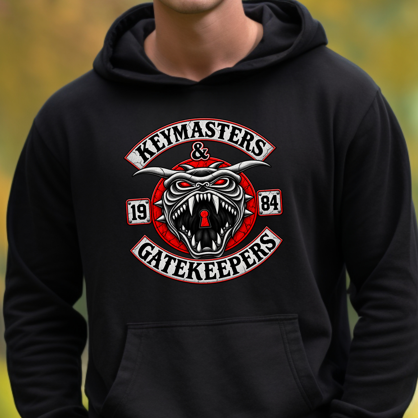 A person wearing a black pullover hoodie with a large graphic on the chest reading 'Keymasters & Gatekeepers' around a snarling red and white keyhole emblem with the numbers 1984.