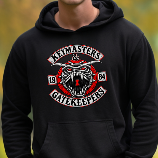 A person wearing a black pullover hoodie with a large graphic on the chest reading 'Keymasters & Gatekeepers' around a snarling red and white keyhole emblem with the numbers 1984.