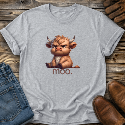 Gray t-shirt with a cartoon bull and 'moo.' text on a wooden surface with jeans and boots.