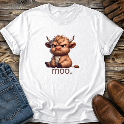 White t-shirt with a cartoon cow and 'moo.' text on a wooden surface with jeans and shoes.