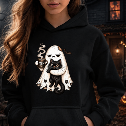 A woman wearing a black hoodie with a graphic of a white ghost holding a black cat, with the text 'MEH' on the cat's head, set against a dark, atmospheric background.