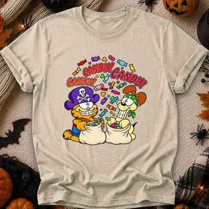 A beige graphic t-shirt featuring Garfield and Odie as pirates filled with candy, surrounded by Halloween decorations like pumpkins and spiderwebs.