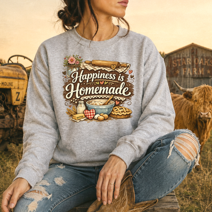 woman wearing a gray sweatshirt with a baking graphic design that says happiness is homemade on it