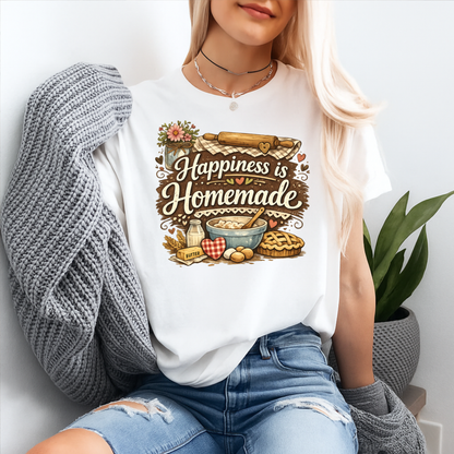 woman wearing a white tshirt with a baking graphic design that says happiness is homemade on it