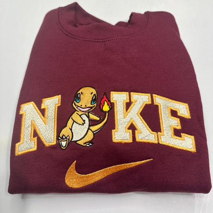 pokemon charmander with the nike logo on a maroon sweatshirt