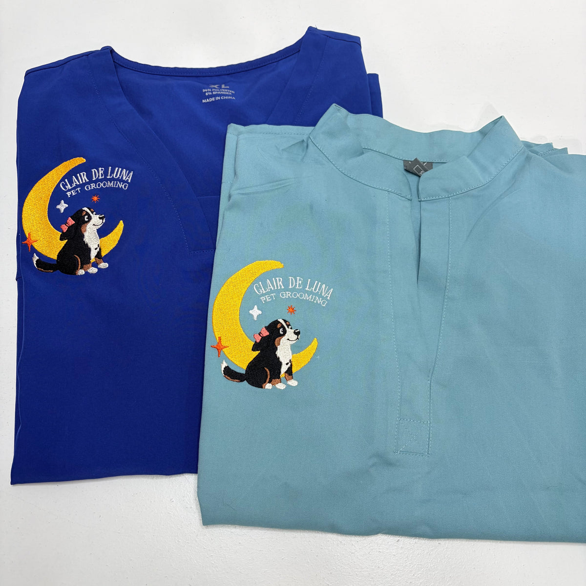 2 embroidered scrub tops with dog grooming logo