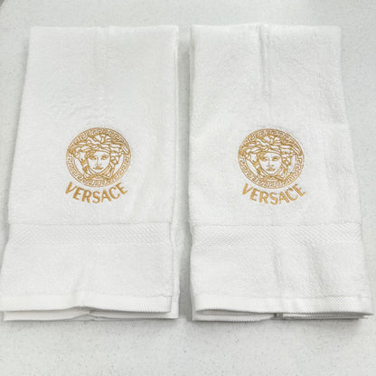 white towels with embroidered versace logos