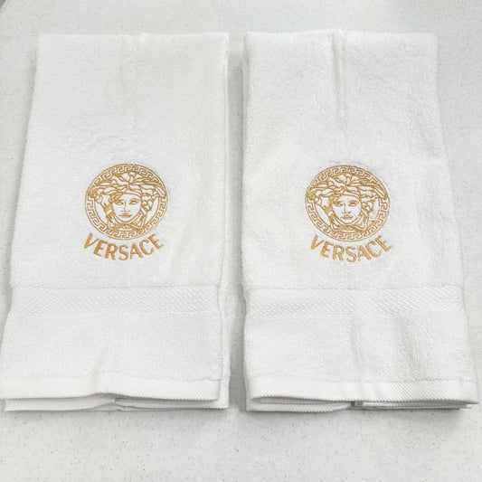 white towels with embroidered versace logos