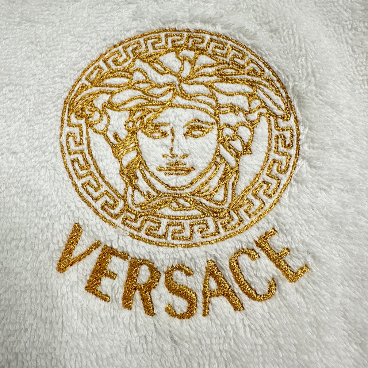 white towel with embroidered versace logo