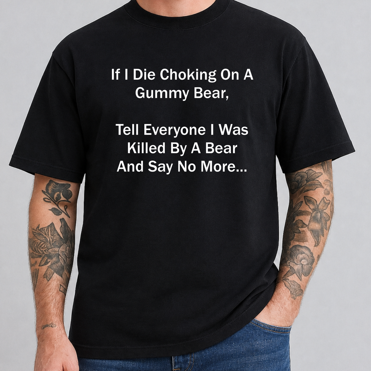 A man wearing a black short-sleeve t-shirt with white printed text that reads, 'If I Die Choking On A Gummy Bear, Tell Everyone I Was Killed By A Bear And Say No More.