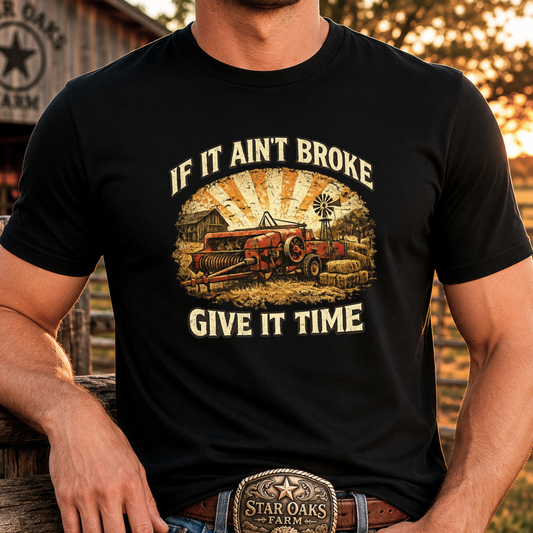 man wearing black tshirt with farm machinery graphic that says if it aint broke give it time