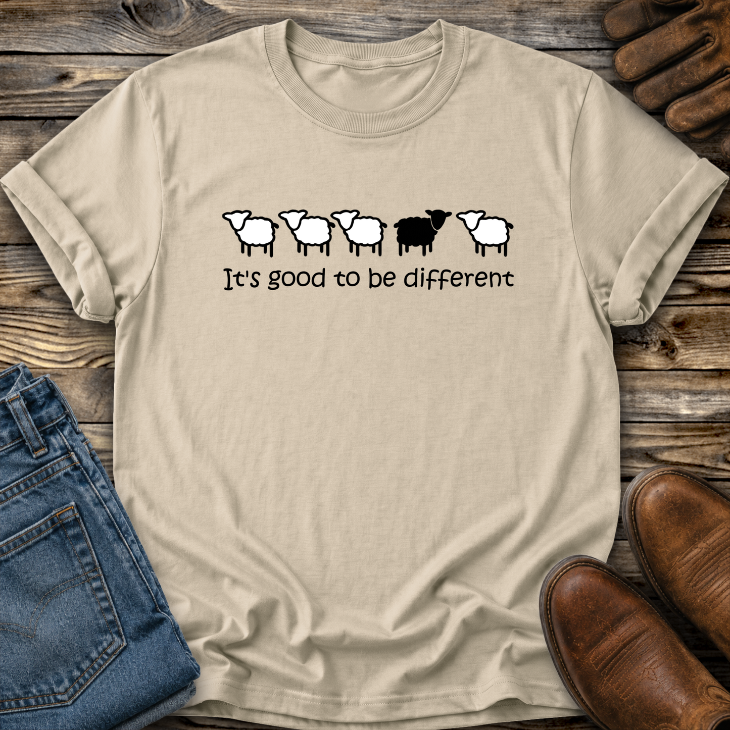 beige tshirt with black sheep that says its good to be different