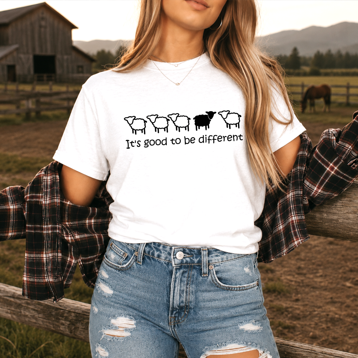 woman wearing a white tshirt with black sheep that says its good to be different