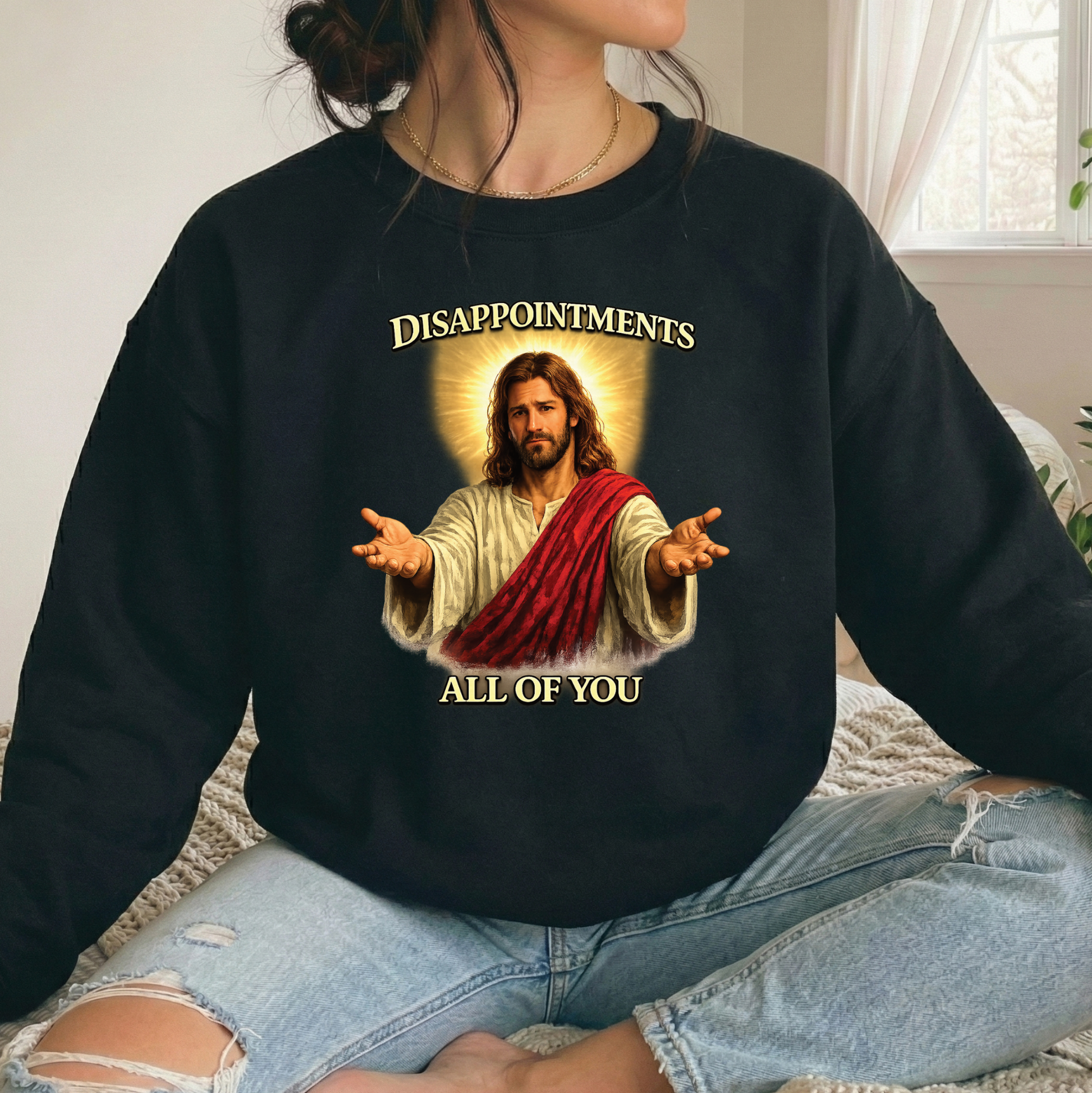 woman wearing black sweatshirt with funny jesus graphic that says disappointments all of you